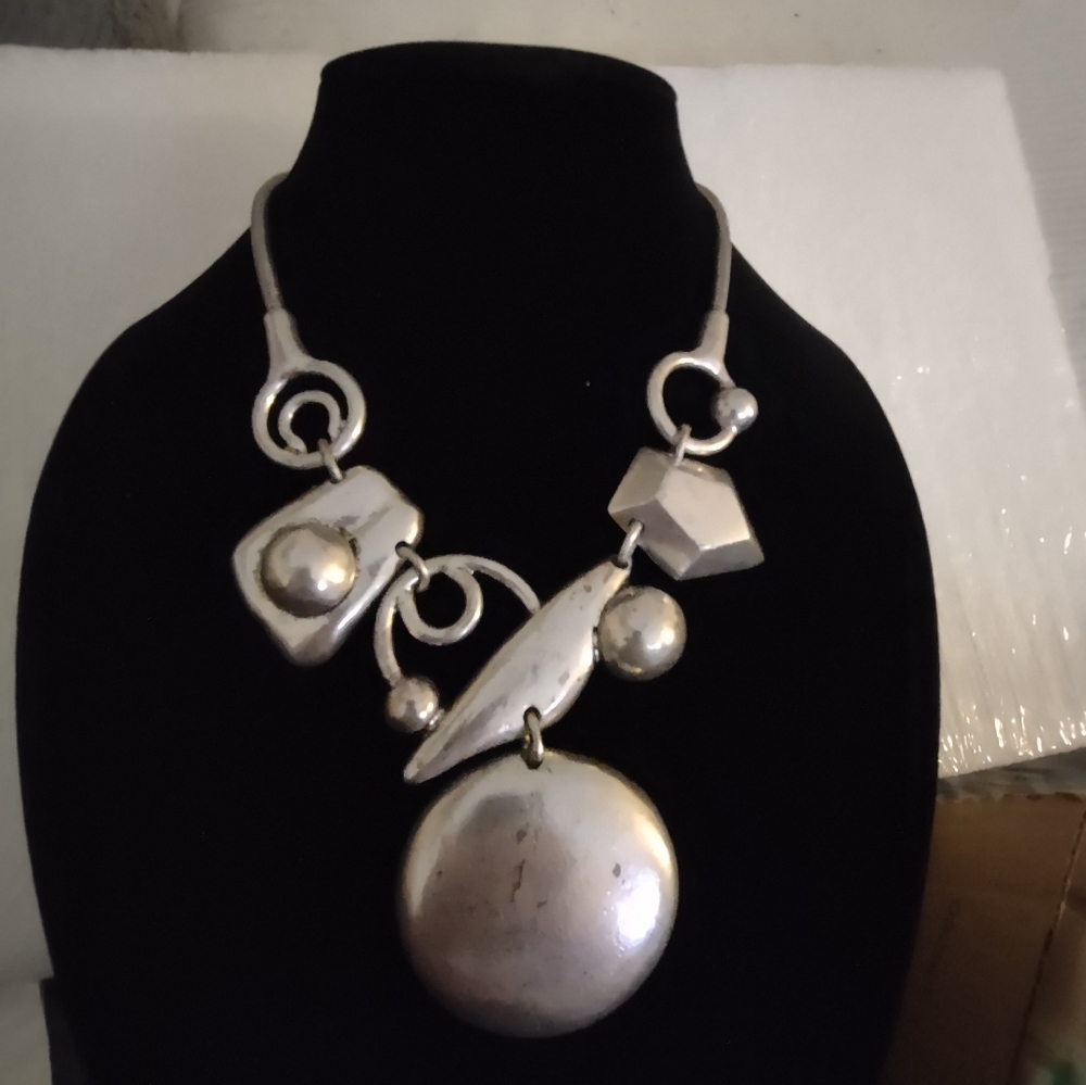 Silver and gold tone metal modernist necklace. This necklace is approximately 18
